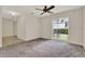 Bedroom featuring neutral carpet, ceiling fan, and a window with vertical blinds at 963 Beach Breeze Dr, Orlando, FL 32835