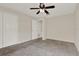 Cozy carpeted bedroom with ceiling fan and closet, offering comfort and storage at 963 Beach Breeze Dr, Orlando, FL 32835