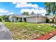Charming single-story home featuring mature trees and a well-maintained lawn at 963 Beach Breeze Dr, Orlando, FL 32835