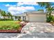 Well-maintained home featuring a spacious driveway and colorful landscaping at 963 Beach Breeze Dr, Orlando, FL 32835