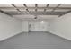 Spacious garage with gray painted floor, white walls, and storage capacity for multiple vehicles at 963 Beach Breeze Dr, Orlando, FL 32835