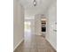 Inviting hallway with neutral tones and tiled flooring, leading to the kitchen at 963 Beach Breeze Dr, Orlando, FL 32835