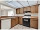 This bright kitchen features ample counter space and wood cabinets and geometric floors at 963 Beach Breeze Dr, Orlando, FL 32835
