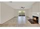 Comfortable living room featuring a fireplace, ceiling fan, and sliding glass doors at 963 Beach Breeze Dr, Orlando, FL 32835