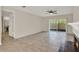 Open-concept living room with fireplace, tile floors, and natural light at 963 Beach Breeze Dr, Orlando, FL 32835