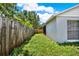 Fenced yard with lush grass surrounding the home's exterior at 963 Beach Breeze Dr, Orlando, FL 32835