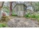 Backyard view showing brick pavers, tropical foliage, and fencing at 9948 Timber Oaks Ct # 14, Orlando, FL 32817
