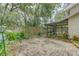 Backyard showcasing brick pavers, tropical foliage, and a screened-in patio for outdoor enjoyment at 9948 Timber Oaks Ct # 14, Orlando, FL 32817