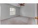 Neutral bedroom with ceiling fan and window with blinds at 9948 Timber Oaks Ct # 14, Orlando, FL 32817