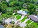 An aerial showcases a home with a pool, beautiful landscaping, and well-maintained lawn within a neighborhood at 107 Laurel Oak Dr, Longwood, FL 32779