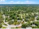 Extensive aerial view reveals a community featuring homes and lush greenery in a sprawling landscape at 107 Laurel Oak Dr, Longwood, FL 32779