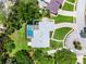 Overhead view featuring the home's roof, pool, manicured lawn, driveway, and mature landscaping at 107 Laurel Oak Dr, Longwood, FL 32779