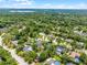 Expansive aerial view of a neighborhood surrounded by lush greenery and blue skies at 107 Laurel Oak Dr, Longwood, FL 32779