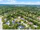 Aerial view of a property with a defined red line, surrounded by lush greenery in a residential area at 107 Laurel Oak Dr, Longwood, FL 32779