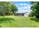 Expansive backyard with green grass, trees, fencing, and a storage shed creating a private outdoor space at 107 Laurel Oak Dr, Longwood, FL 32779