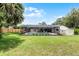 Backyard view showcasing a screened pool, lush lawn, and a storage shed, perfect for outdoor living at 107 Laurel Oak Dr, Longwood, FL 32779