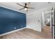 Bedroom featuring a striking blue accent wall, wood floors, and a double door closet at 107 Laurel Oak Dr, Longwood, FL 32779