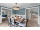 Inviting dining room with blue walls, wainscoting, and dining table, flowing to the kitchen at 107 Laurel Oak Dr, Longwood, FL 32779