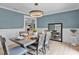 Elegant dining room with modern chandelier, table set for six, and light blue accent wall at 107 Laurel Oak Dr, Longwood, FL 32779