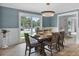 Dining area featuring a wooden table, seating for six, and bright natural light from the windows at 107 Laurel Oak Dr, Longwood, FL 32779