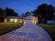 Charming home exterior featuring a stone facade, well-manicured lawn, and inviting driveway at 107 Laurel Oak Dr, Longwood, FL 32779