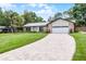 Picturesque home with a lush green lawn, stone accents, and a brick driveway creating a welcoming exterior at 107 Laurel Oak Dr, Longwood, FL 32779