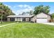 Desirable home boasting a pristine lawn, stone facade accents, and a well-designed walkway enhancing curb appeal at 107 Laurel Oak Dr, Longwood, FL 32779