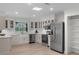 Bright, modern kitchen with stainless steel appliances, white cabinetry and a farm sink at 107 Laurel Oak Dr, Longwood, FL 32779