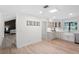 Bright kitchen view featuring skylight, white cabinets, stainless appliances and adjoining living room at 107 Laurel Oak Dr, Longwood, FL 32779