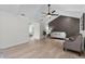 Bright living room with vaulted ceilings, fan, accent wall, and light wood flooring at 107 Laurel Oak Dr, Longwood, FL 32779