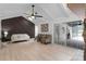 Spacious living room with a vaulted ceiling, stone accent wall, hardwood floors, and sliding glass doors at 107 Laurel Oak Dr, Longwood, FL 32779