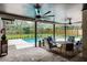 Screened patio with ceiling fans, seating area, and backyard views perfect for outdoor entertaining and relaxation at 107 Laurel Oak Dr, Longwood, FL 32779