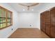 Bedroom features wood floors, a ceiling fan, and a closet with louvered doors at 111 Main St, Windermere, FL 34786
