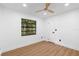 Bedroom features wood floors, a ceiling fan, and a view to the outside at 111 Main St, Windermere, FL 34786