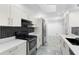 Well-lit kitchen with modern appliances and stylish hexagonal backsplash at 111 Main St, Windermere, FL 34786