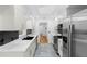 Modern kitchen with white cabinets, stainless steel appliances, and backsplash at 111 Main St, Windermere, FL 34786