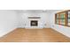 Bright living room features sleek wood floors and a cozy fireplace at 111 Main St, Windermere, FL 34786