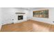 Bright living room features sleek wood floors and a cozy fireplace at 111 Main St, Windermere, FL 34786