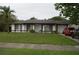 Traditional home with a garage and a green front lawn at 11418 Ashboro Dr, Orlando, FL 32837