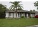 Inviting single-story home featuring a well-maintained lawn and mature palm tree in the front yard at 11418 Ashboro Dr, Orlando, FL 32837