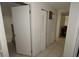 Hallway with white doors, tile floors, and ample closet space at 11418 Ashboro Dr, Orlando, FL 32837