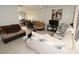Open-concept living room featuring neutral-toned furniture and tile flooring at 11418 Ashboro Dr, Orlando, FL 32837