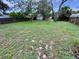 Large, fenced backyard with mature trees, offering ample green space and privacy at 1292 Nadine Dr, Deltona, FL 32738