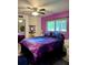 Cozy bedroom featuring galaxy-themed bedding, complemented by colorful walls and a ceiling fan at 1292 Nadine Dr, Deltona, FL 32738