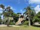 Eye-catching house with unique design, surrounded by mature landscaping and trees at 1292 Nadine Dr, Deltona, FL 32738