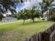 Well-maintained front yard features mature trees, a lush green lawn, and a charming residential neighborhood at 1292 Nadine Dr, Deltona, FL 32738