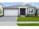 Charming one-story home featuring a two-car garage, covered entryway, and neatly landscaped front yard at 13232 Pergola Ave, Orlando, FL 32832