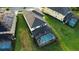 Aerial view of home with screened-in pool and jacuzzi and solar panels on the roof at 1544 Nassau Point Trl, Kissimmee, FL 34747