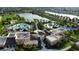 Aerial view of community pool, clubhouse, and amenities, with a lake and fountain in the background at 1544 Nassau Point Trl, Kissimmee, FL 34747