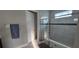 Bathroom with a sliding glass door shower, tiled floors, and a gray color scheme at 1544 Nassau Point Trl, Kissimmee, FL 34747